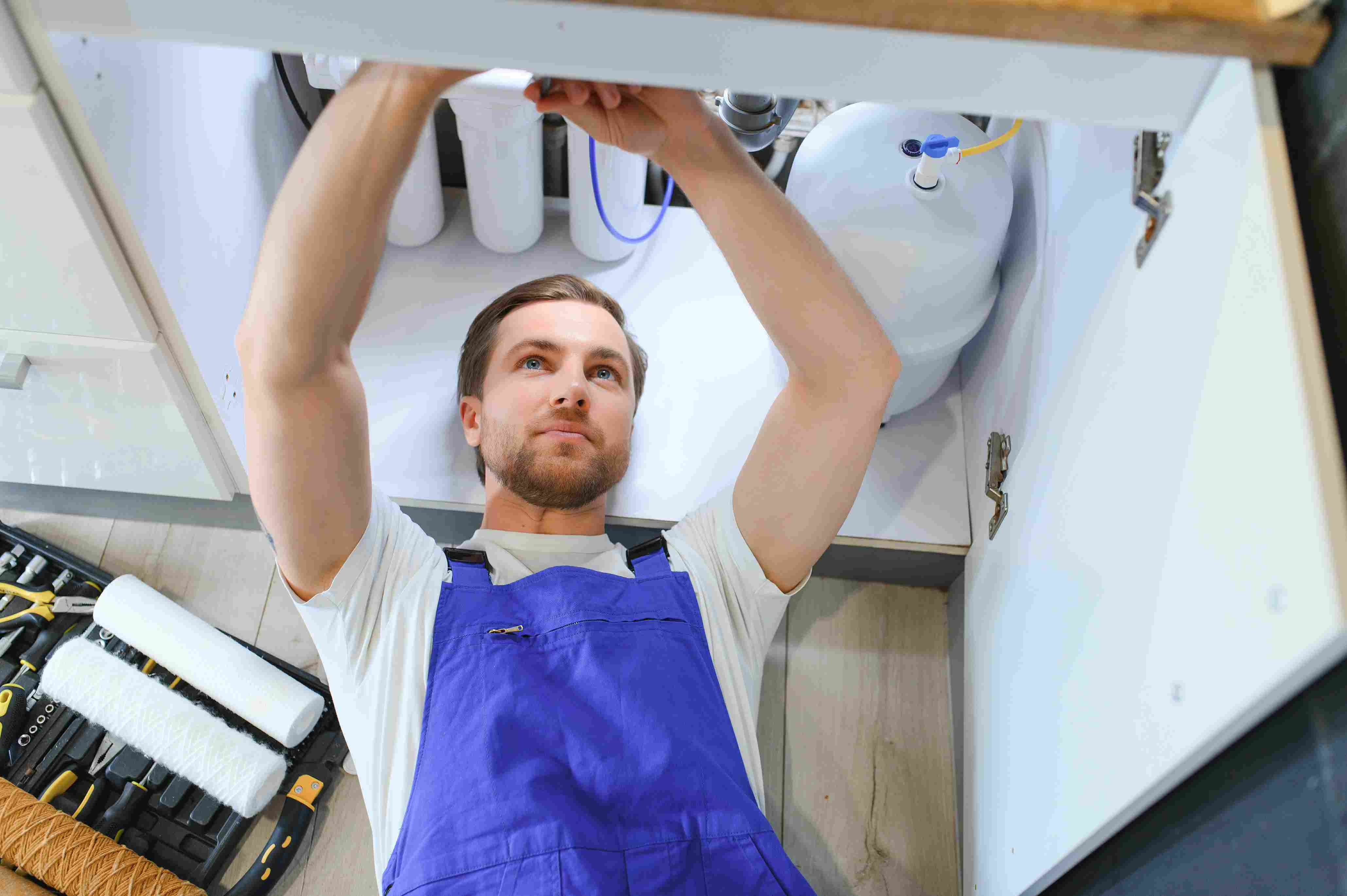 repairman-installing-water-filter-cartridges-in-a